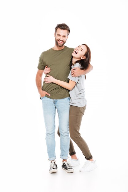 Happy young loving couple standing isolated