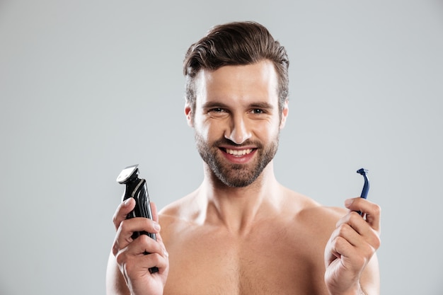 Happy young man choosing razor