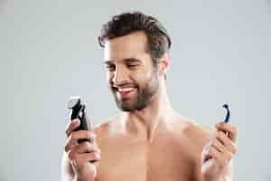 Free photo happy young man choosing razor