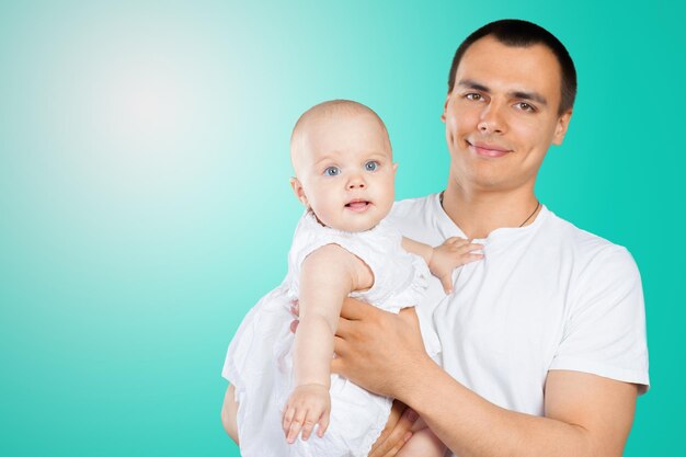 Happy young man holding a baby