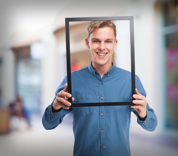 happy young-man  holding a black frame