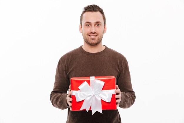 Happy young man holding gift box surprise.