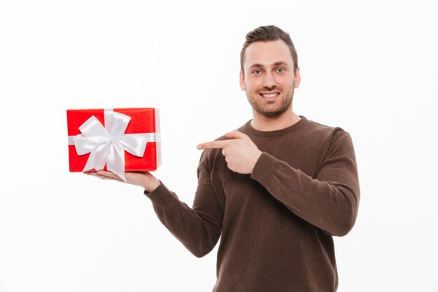 Happy young man holding gift box surprise.