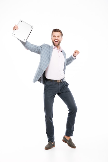 Happy young man standing isolated