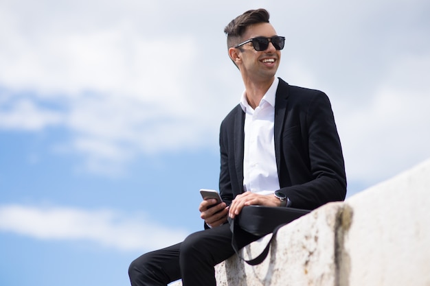 Happy young man in suit enjoying stroll