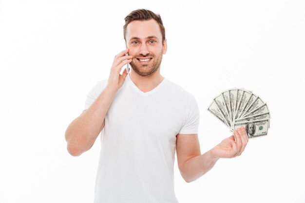 Happy young man talking by mobile phone.