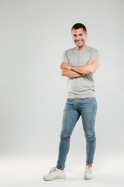 Free photo happy young man with arms crossed.