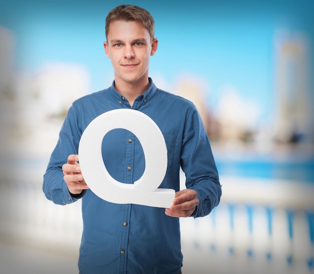 happy young man with q letter