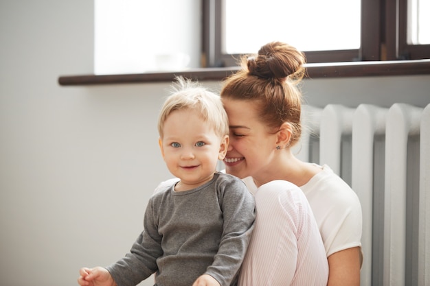 Happy Young Mother With Little Son At Home