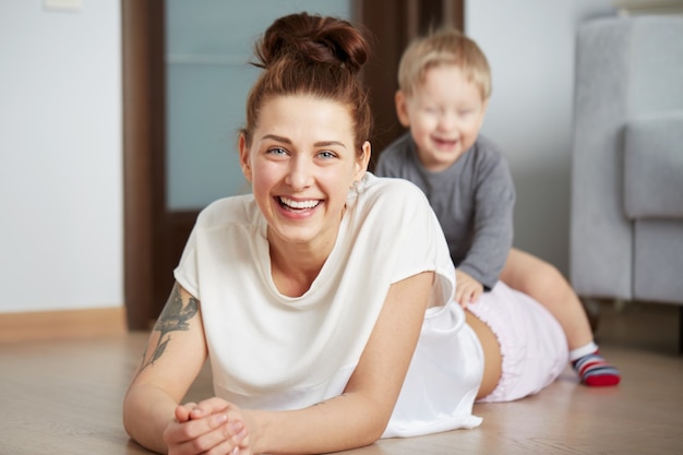 Happy young mother with little son at home