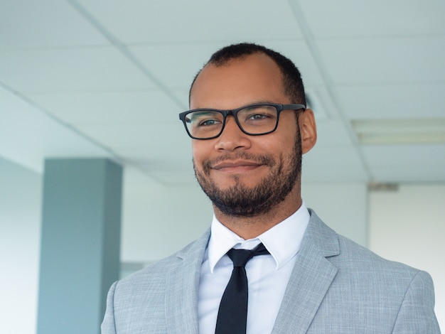 Free photo happy young professional posing in office