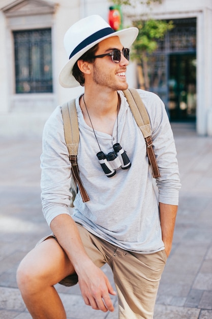 Happy young tourist posing with sunglasses