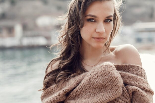 happy young woman in cozy wear outdoors