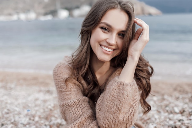 happy young woman in cozy wear outdoors
