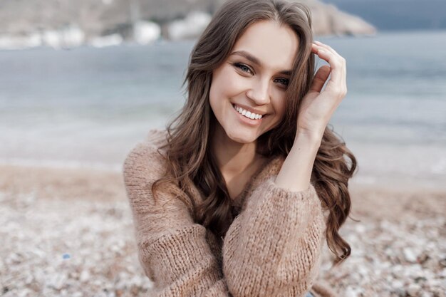 happy young woman in cozy wear outdoors