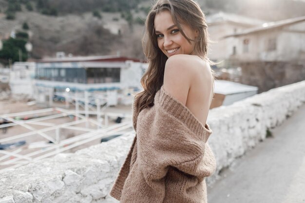 happy young woman in cozy wear outdoors