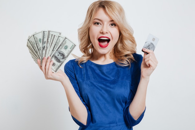 Happy young woman holding money