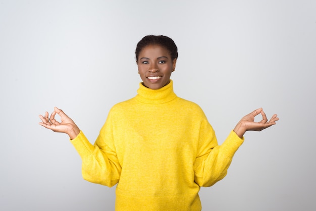 Happy young woman meditating and smiling