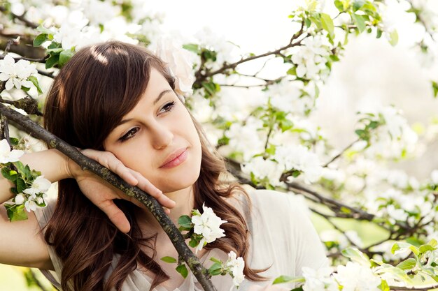 Happy young woman in the orchard
