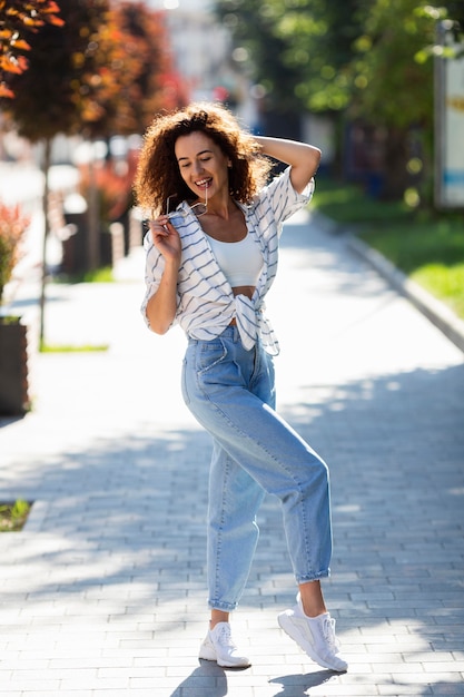 Happy young woman posing outdoors