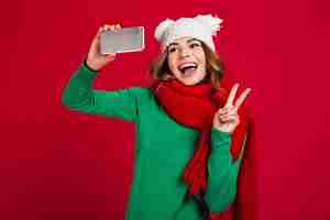 Free photo happy young woman showing peace gesture.