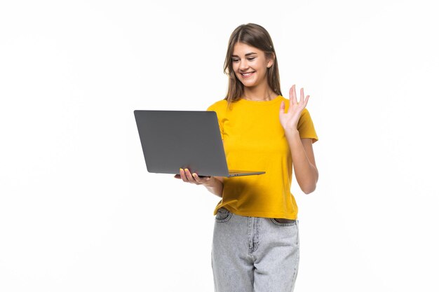 Happy young woman student chatting on conference video call looking at laptop on white