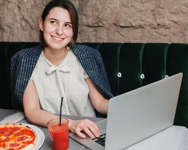 Happy young woman using laptop