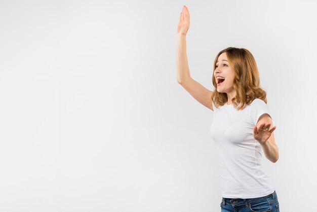 Happy young woman waving her hand isolated over white background