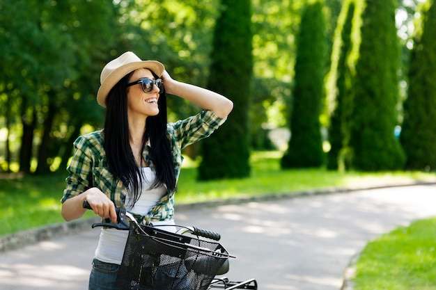 Happy young woman with bicycle
