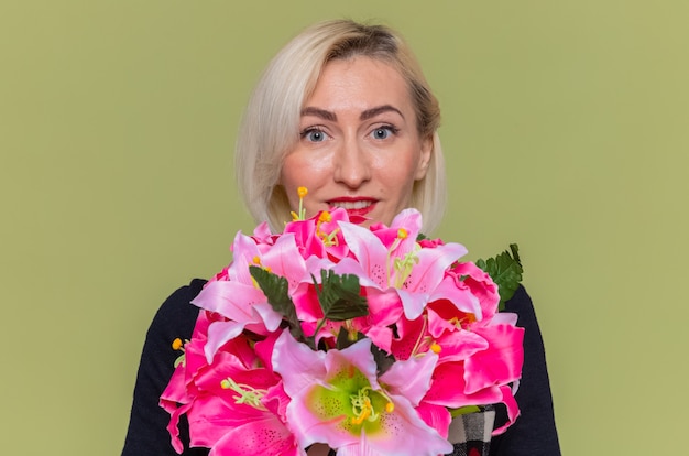 happy young woman with bouquet of flowers