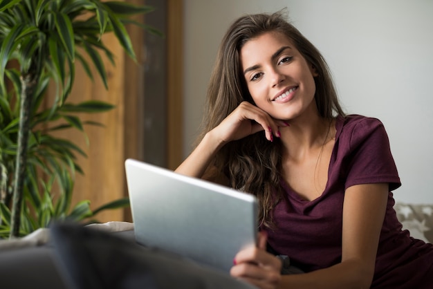 Happy young woman with digital tablet