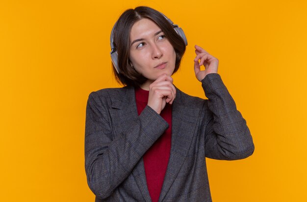 Happy young woman with short hair wearing grey jacket