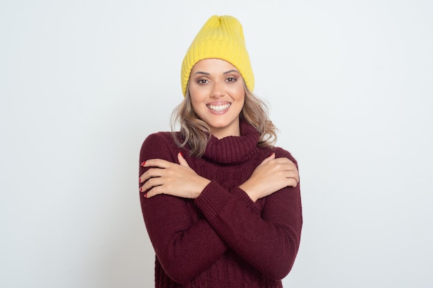 Happy young woman in yellow hat