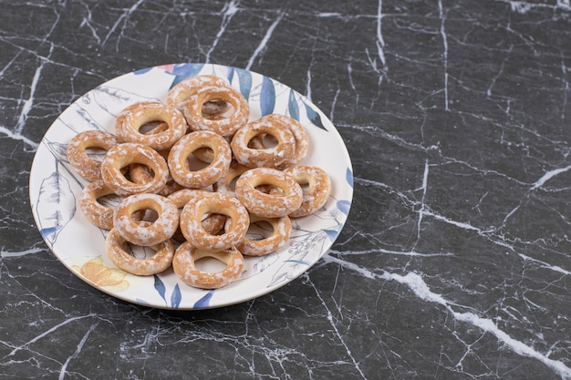 Hard salted pretzels on colorful plate.