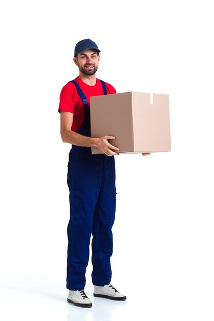 Hard worker courier man holding a big box long view