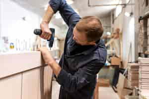 Free photo hardworking man doing his job in a woodshop