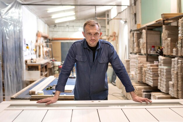 Hardworking man doing his job in a woodshop