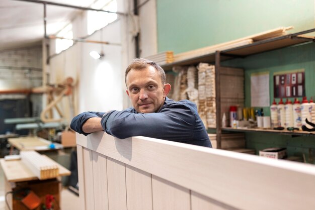 Hardworking man doing his job in a woodshop