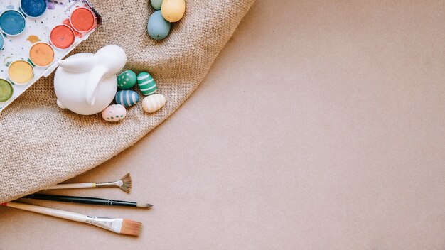 Hare figurine with eggs on canvas