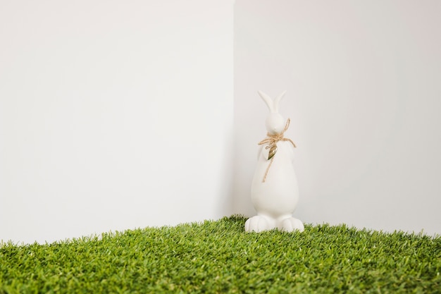 Free photo hare with bow figurine on grass