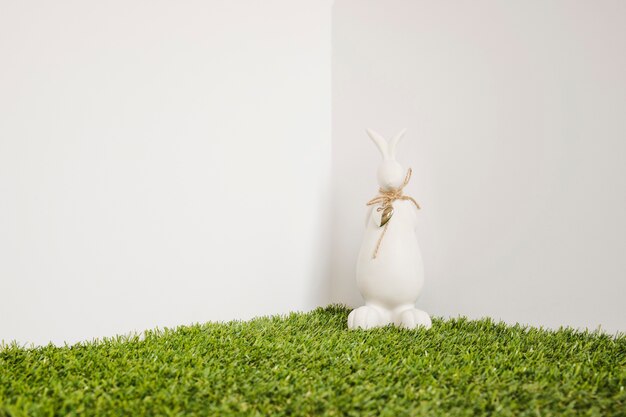 Hare with bow figurine on grass