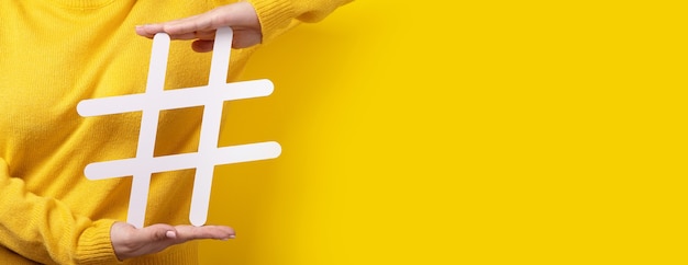 Hashtag sign in hand, concept of technology, communication, online marketing, beauty industry