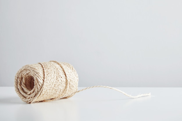 Hasp of craft rope isolated in side of white table