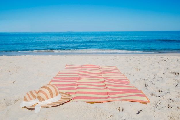 Hat and blanket on beach