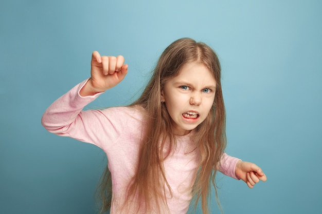 The hate. Teen girl on a blue. Facial expressions and people emotions concept