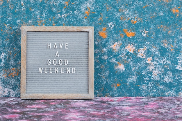 Have a good weekend poster on blue surface