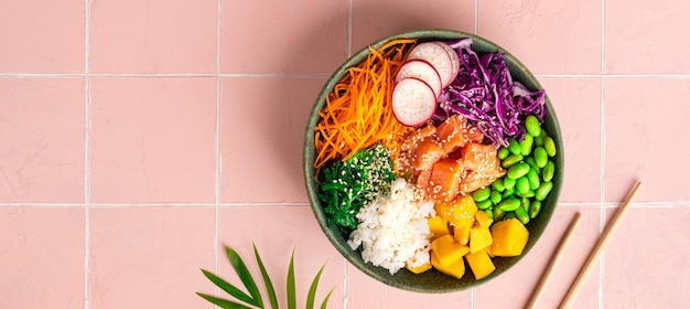Hawaiian poke bowl with salmon in a bowl with seaweed sesame seeds and cabbage Top view flat lay Banner