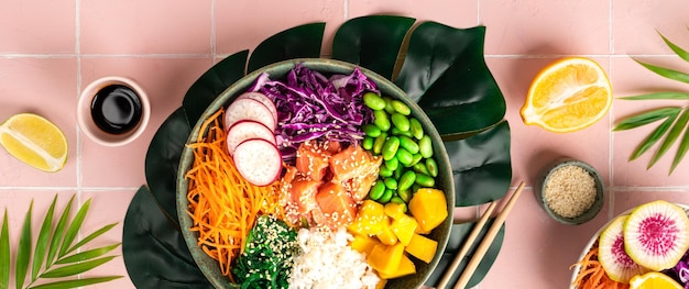 Hawaiian poke bowl with salmon in a bowl with seaweed sesame seeds and cabbage Top view flat lay Banner