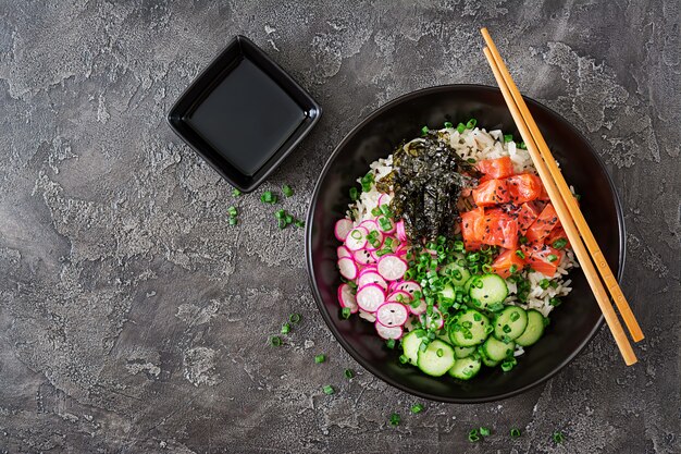 Hawaiian salmon fish poke bowl with rice. Top view. Flat lay