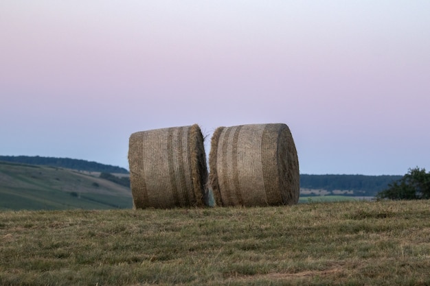 Free photo haystacks on the hill in the rural area